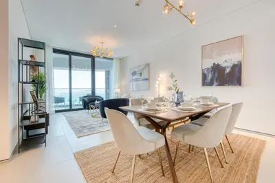 a dining room with a table and chairs at Address JBR with Sea View & Maid Room - Mint Stay in Dubai