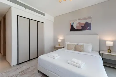 a bedroom with a white bed with two towels on it at Address JBR with Sea View & Maid Room - Mint Stay in Dubai