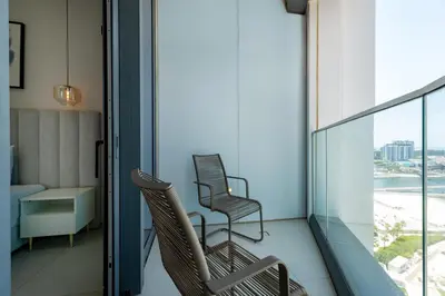 two chairs on a balcony with a view of the ocean at Address JBR with Sea View & Maid Room - Mint Stay in Dubai