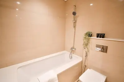 a bathroom with a white tub and a toilet at cinematic&Chic Burj Khalifa &Fountain View 2BR APT in Dubai