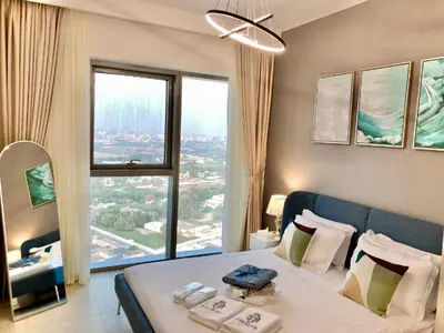 a bedroom with a large bed with a large window at Luxurious 1-bedroom With Skyline View In Downtown Views Ii in Dubai
