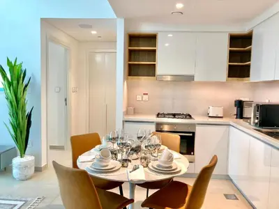 a dining room with a table and chairs in a kitchen at Luxurious 1-bedroom With Skyline View In Downtown Views Ii in Dubai