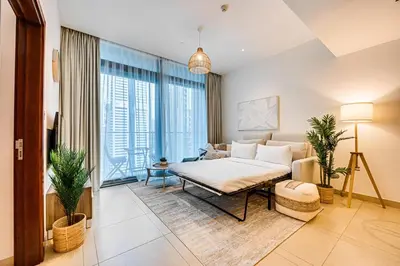 a living room with a bed and a couch at Amazing 1 BD in Marina Gate 2 Dubai Marina in Dubai