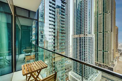 a wooden bench on a balcony in a city at Amazing 1 BD in Marina Gate 2 Dubai Marina in Dubai