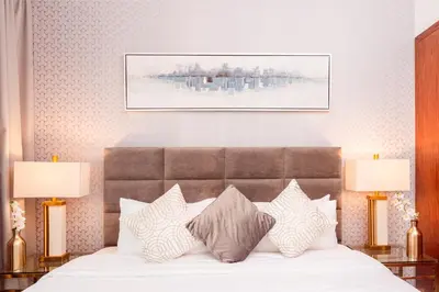 a bedroom with a bed with pillows and two lamps at Elite Royal Apartment - Full Burj Khalifa & Fountain View - 2 Bedrooms + 1 Open Bedroom Without Partition - Magnate in Dubai