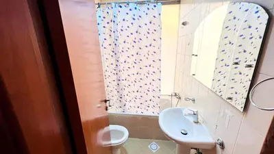 a bathroom with a sink and a toilet and a mirror at Cityview Partition Room with Balcony in Tecom in Dubai