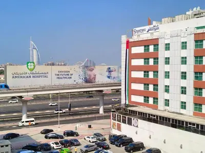a parking lot with cars on a highway next to a building at Partition Room 3 Mins to Mashreq Metro in Dubai