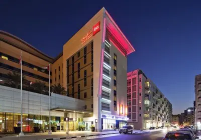 a building on a city street at night at Partition Room 3 Mins to Mashreq Metro in Dubai
