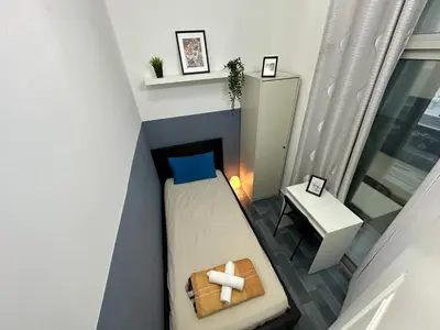 a small room with a bed and a table at Partition Room 3 Mins to Mashreq Metro in Dubai