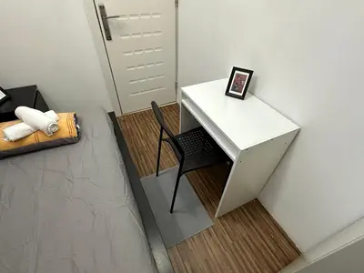 a white desk with a chair next to a door at Prime Partition Room in Al Barsha 1 Near Metro in Dubai