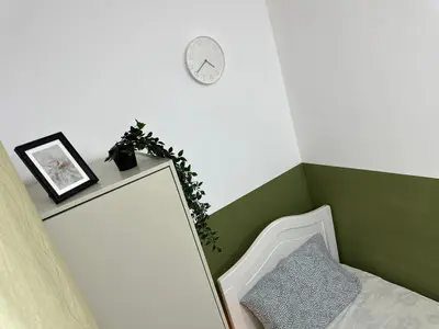 a room with a mirror and a clock on the wall at Bachelor Partition Room in Tecom Near Internet City Metro in Dubai