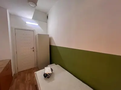 a small room with a green and white wall at Bachelor Partition Room in Tecom Near Internet City Metro in Dubai