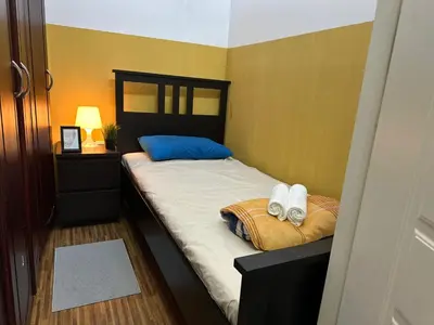 a bedroom with a bed with two towels on it at Cozy Partition Room Near Mashreq & MOE Metro in Dubai