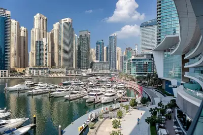 a group of boats docked in a harbor in a city at Luxurious 2BR apt with panoramic Marina view in Dubai