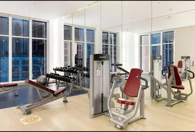a gym with cardio equipment and a large mirror at Phineek Elegant Studio Canal View Maison Prive Business Bay in Dubai
