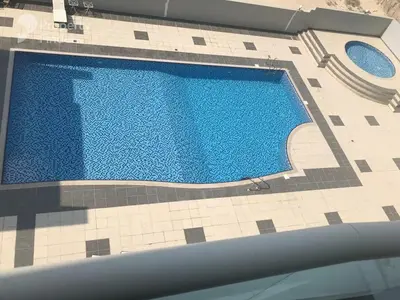 an overhead view of a swimming pool in a building at Elite Studio at Dubai Marina in Dubai