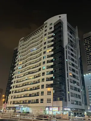 a large building at night with cars in front of it at Elite Studio at Dubai Marina in Dubai