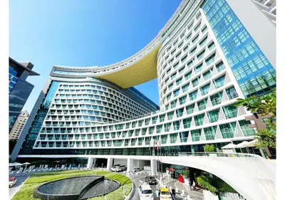 a large office building with a large building at First Class Apartments in Seven Palm with direct Access to the West Palm Beach and Nakheel Mall in Dubai