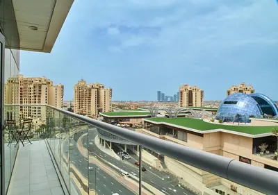a view of a city from a balcony at First Class Apartments in Seven Palm with direct Access to the West Palm Beach and Nakheel Mall in Dubai