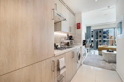 a kitchen with a sink and a dishwasher at First Class Apartments in Seven Palm with direct Access to the West Palm Beach and Nakheel Mall in Dubai