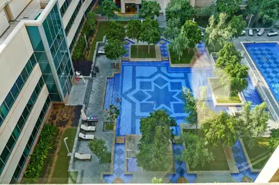 an overhead view of a swimming pool in a building at Cute 1 BR - Walk to Opera, Mall & Burj Khalifa in Dubai