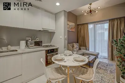 a kitchen and dining room with a table and chairs at Mira Holiday Homes - Serviced apartment in Zada Tower in Dubai