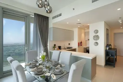 a dining room and kitchen with a table and chairs at Chic 2-Bedroom Downtown Gem in Dubai