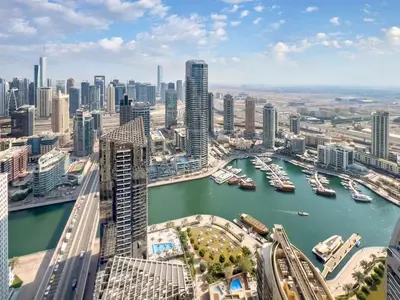 an aerial view of a city with boats in the water at FAM Living- Luxe Penthouse in JBR Marina - Panaromic Sea View in Dubai