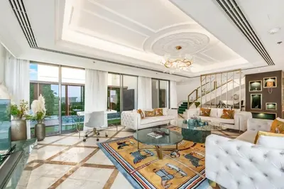 a living room with white furniture and a glass table at FAM Living- Luxe Penthouse in JBR Marina - Panaromic Sea View in Dubai