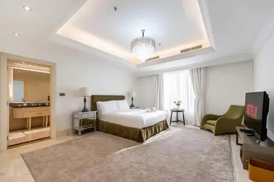a hotel room with a bed and a couch and a television at FAM Living- Luxe Penthouse in JBR Marina - Panaromic Sea View in Dubai