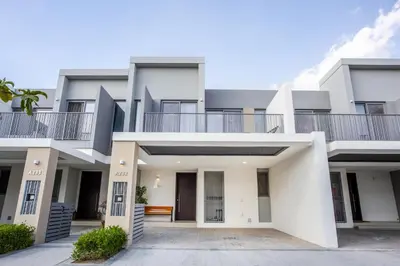 a large white building with a balcony on top at Three Bedroom Villa with Maid Room in Tilal Al Ghaf by The S Holiday Homes in Dubai