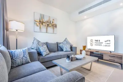 a living room with a couch and a table at Three Bedroom Villa with Maid Room in Tilal Al Ghaf by The S Holiday Homes in Dubai