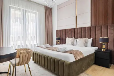 a bedroom with a large bed and a desk at Spacious 1 bed in La Mer - 1 min to the beach in Dubai
