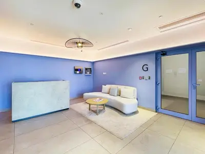 a living room with a couch and a table at Spacious 1 bed in La Mer - 1 min to the beach in Dubai