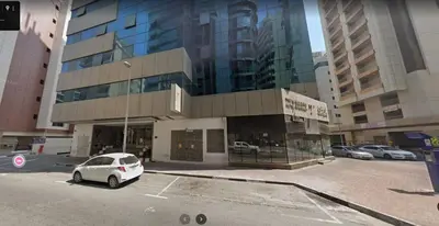 a white car parked in front of a building at Flexible Small Partition Room Near MOE in Dubai