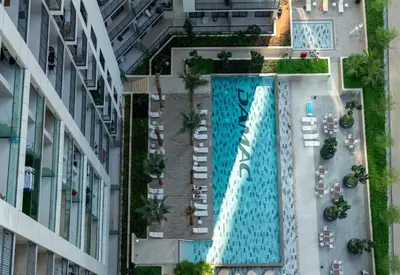 an overhead view of a swimming pool in a building at Stylish Apartment in Dubai