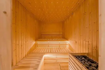 a wooden sauna with a bench in the middle at Stylish Apartment in Dubai