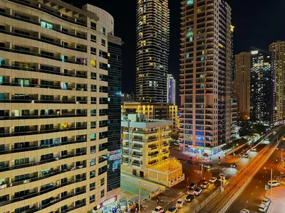 a view of a city at night with tall buildings at Comfy Studio w/ Balcony & Nice Design in Marina in Dubai