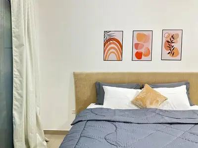 a bedroom with a bed with four pictures on the wall at Comfy Studio w/ Balcony & Nice Design in Marina in Dubai