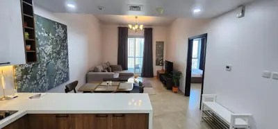 a kitchen and living room with a couch and a table at Preatoni Tower - JLT by Golden Casa in Dubai