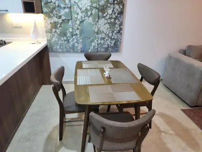 a dining room with a wooden table and chairs at Preatoni Tower - JLT by Golden Casa in Dubai