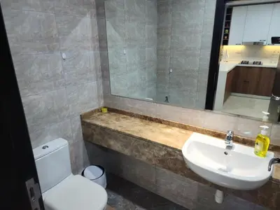 a bathroom with a sink and a toilet and a mirror at Preatoni Tower - JLT by Golden Casa in Dubai