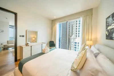 a bedroom with a large bed and a large window at Luton Vacation Homes - Tranquil 2BR Haven in the Heart of Dubai Marina- 28AB04 in Dubai