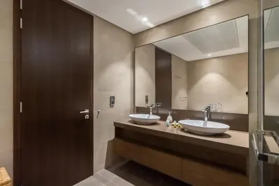 a bathroom with two sinks and a large mirror at Luton Vacation Homes - Tranquil 2BR Haven in the Heart of Dubai Marina- 28AB04 in Dubai