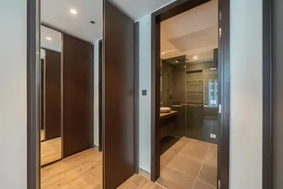 a bathroom with a glass door leading to a shower at Luton Vacation Homes - Tranquil 2BR Haven in the Heart of Dubai Marina- 28AB04 in Dubai