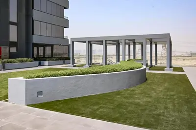 an external view of a building with green grass at Cozy Studio 29th Floor, Bloom Towers Marina View in Dubai