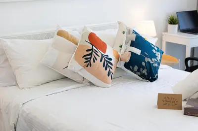 a white bed with pillows on top of it at Cozy Studio 29th Floor, Bloom Towers Marina View in Dubai