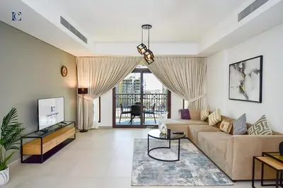 a living room with a couch and a table at Luxury Escapes - Contemporary 2BR Gem in Madinat Jumeirah - RAHAAL in Dubai