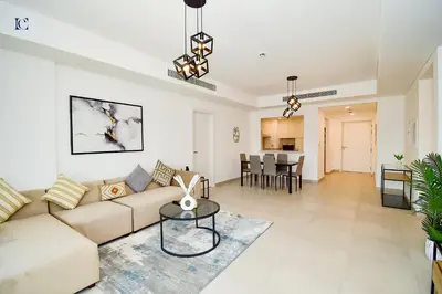 a living room with a couch and a table at Luxury Escapes - Contemporary 2BR Gem in Madinat Jumeirah - RAHAAL in Dubai
