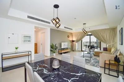 a living room with a table and a couch at Luxury Escapes - Contemporary 2BR Gem in Madinat Jumeirah - RAHAAL in Dubai
